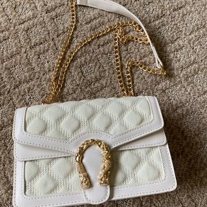 Off white/ gold fashion purse. Never used